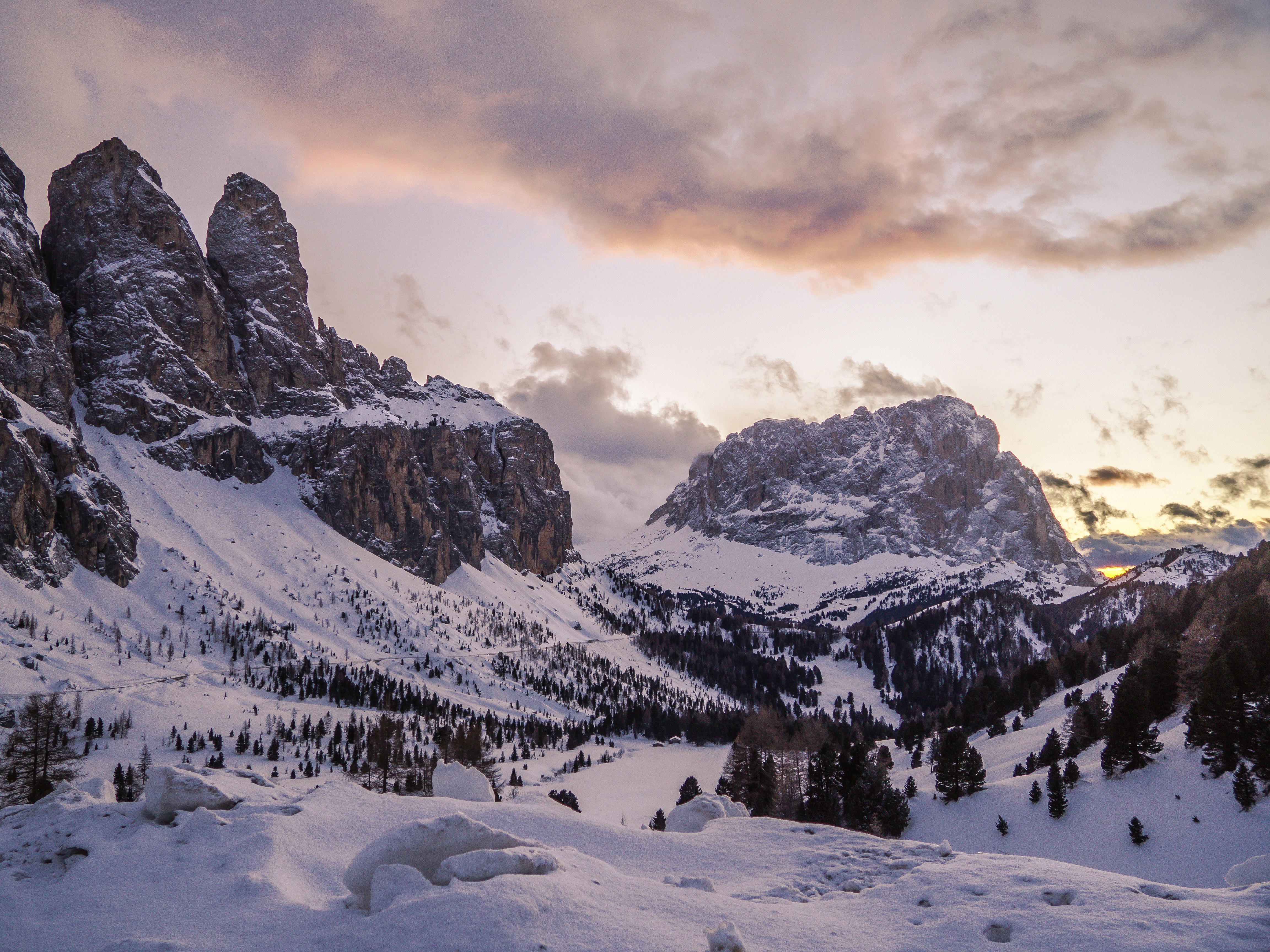 Sunset over snow covered mountain peaks of Val Gardena in the Dolomites