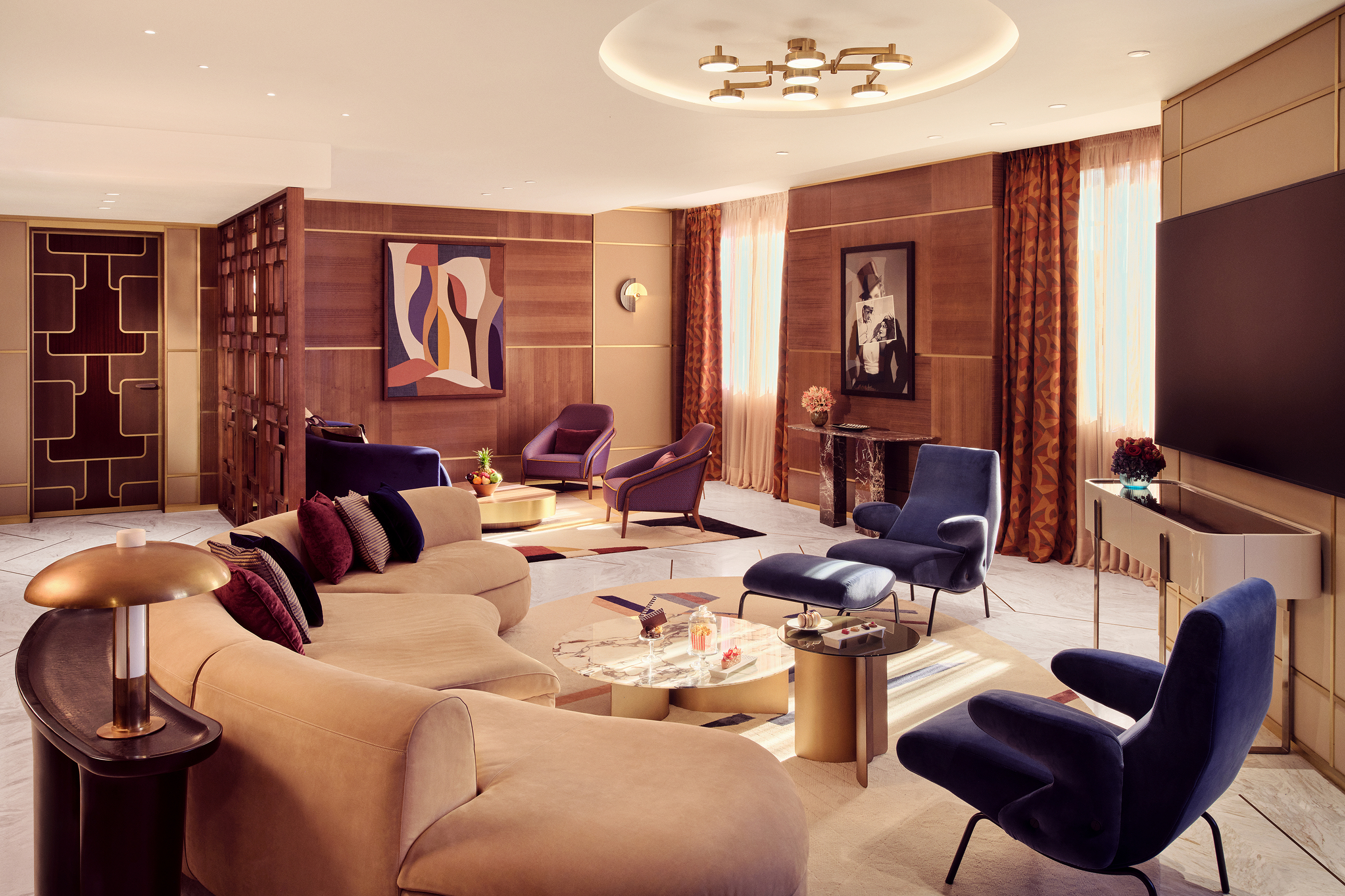 A large apartment suite lounge at Royal Mansour Casablanca with plush mid-century furniture, large artwork and geometric room dividers