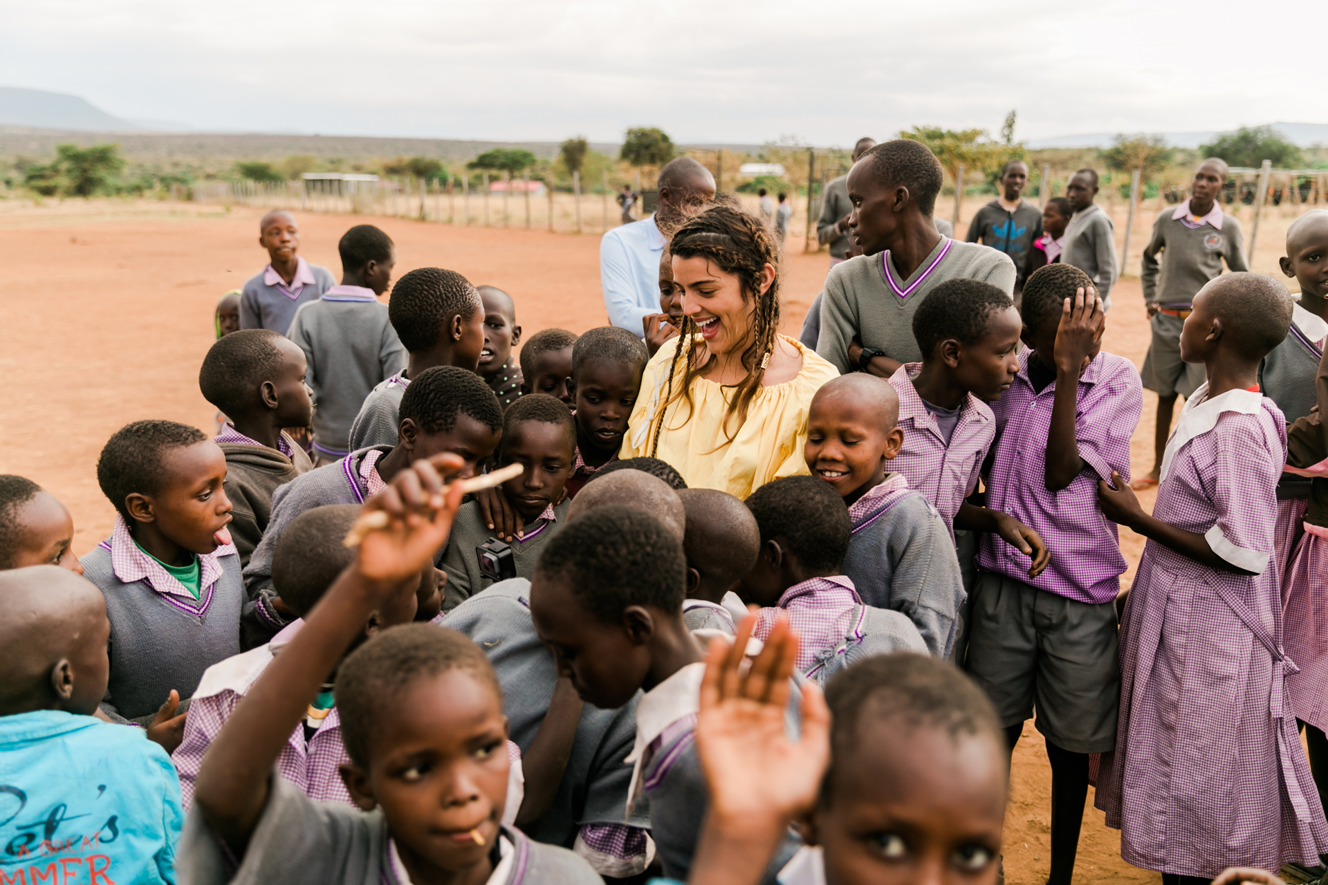 Kenyan school children stood around a tourist