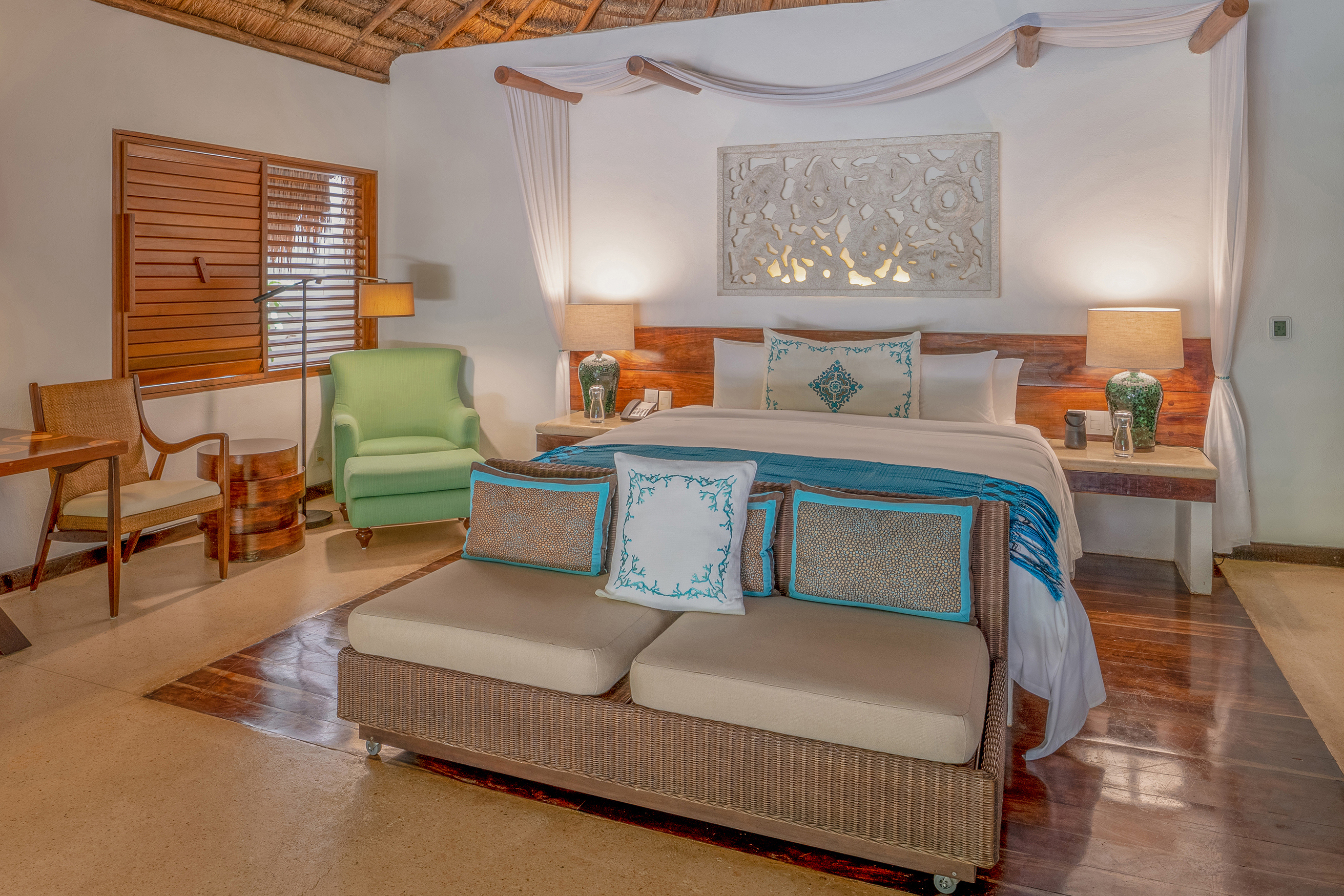 Interior of a luxury villa at Viceroy Riviera Maya featuring colourful furniture and wooden accents
