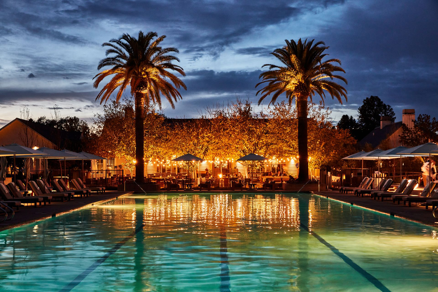 North America, USA, California, Solage Resorts Auberge Collection, Poolside at Dusk, lit by garland lighting