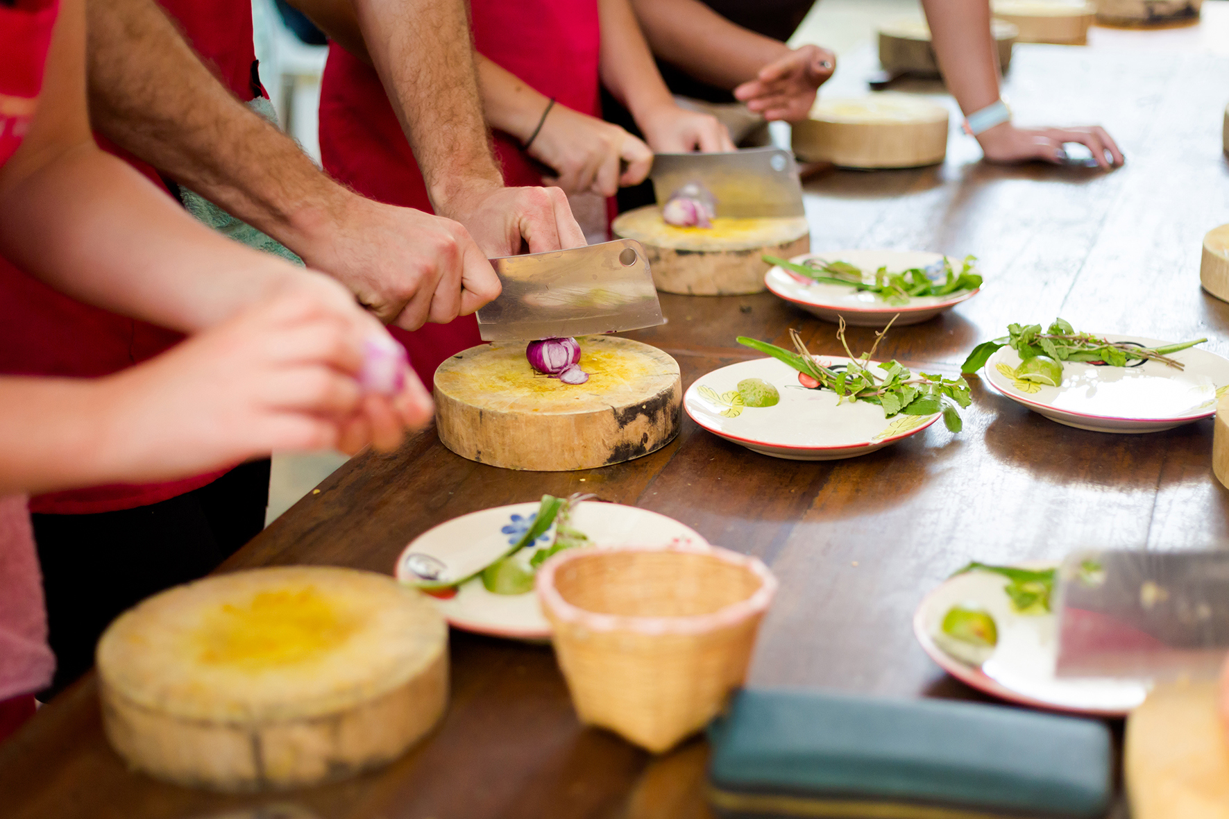 Group of people preparing food in a Thai cooking class