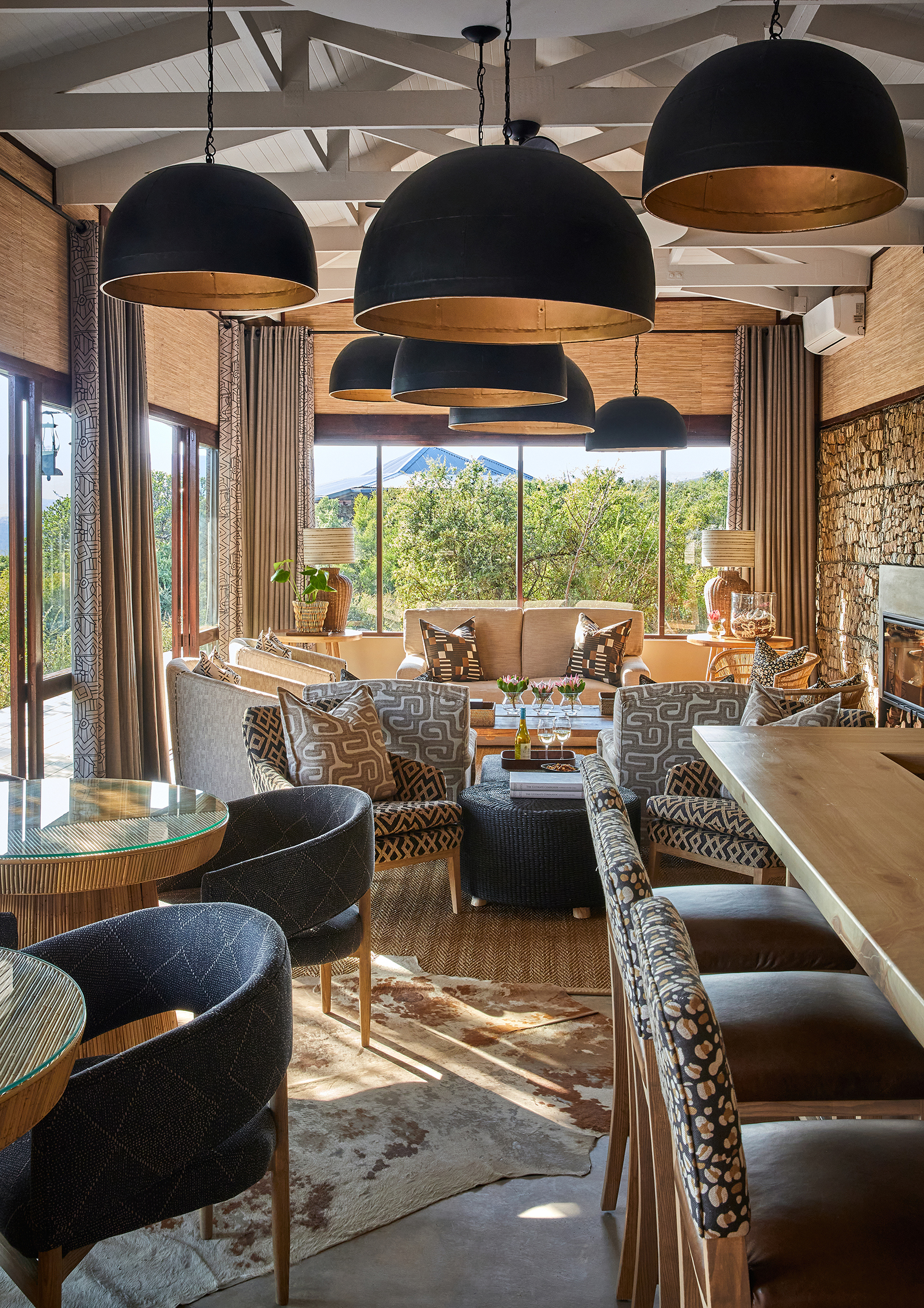 Bar and seating area of Great Fish River Lodge with large domed ceiling lights and plush chairs