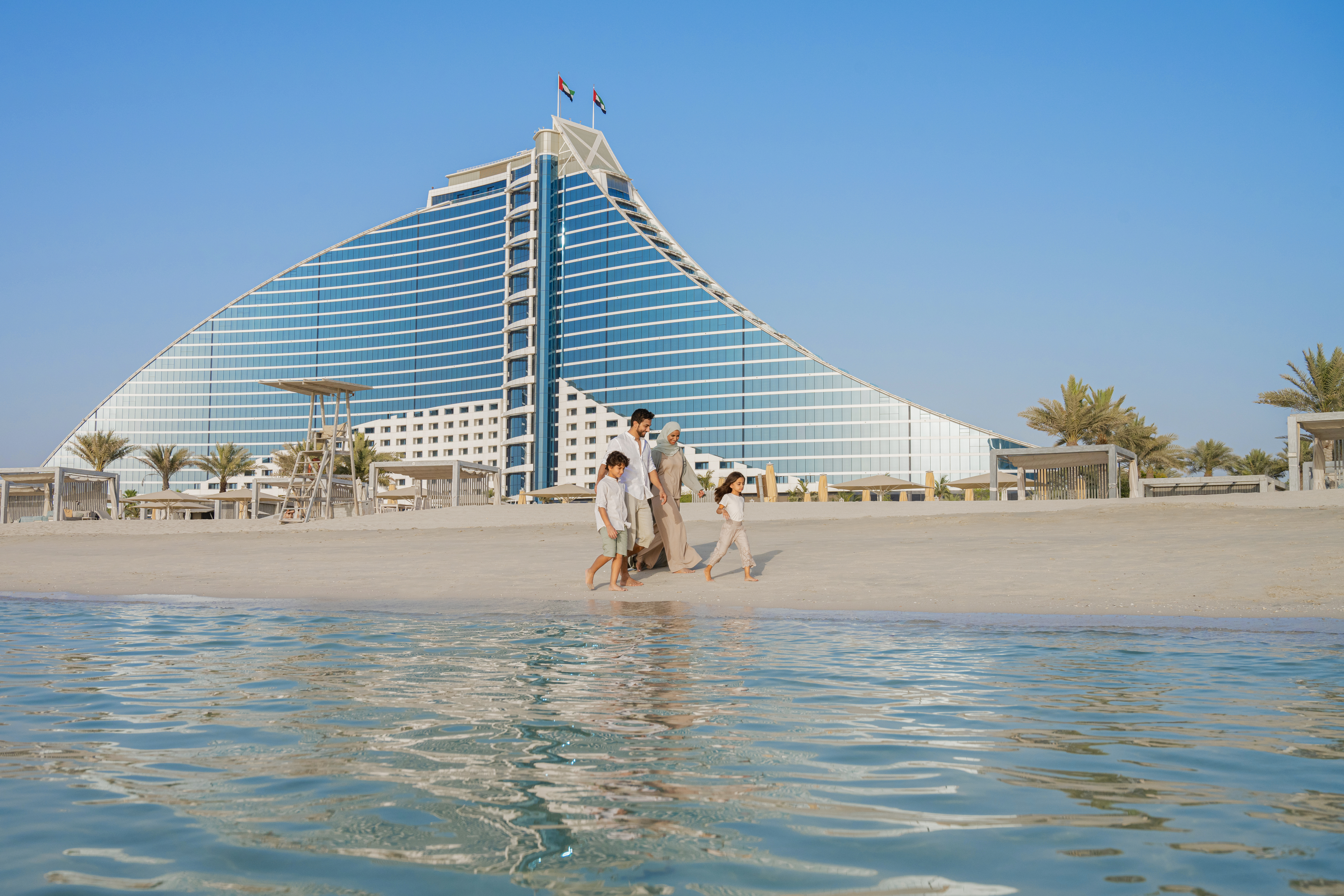 Arabia, Dubai, Jumeirah Beach Hotel Arabic Family Beach Running Dressed